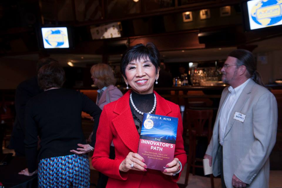 An Axiom medalist holding their award-winning book