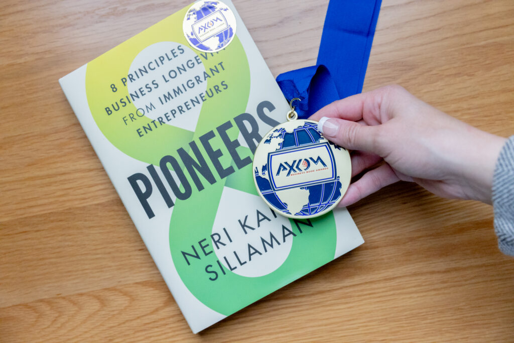 Axiom medal in hand by book